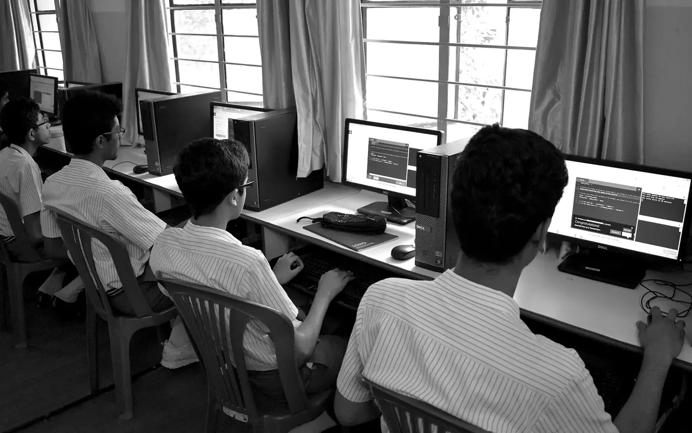 Students learning to code at a row of computers in a Bengaluru school.