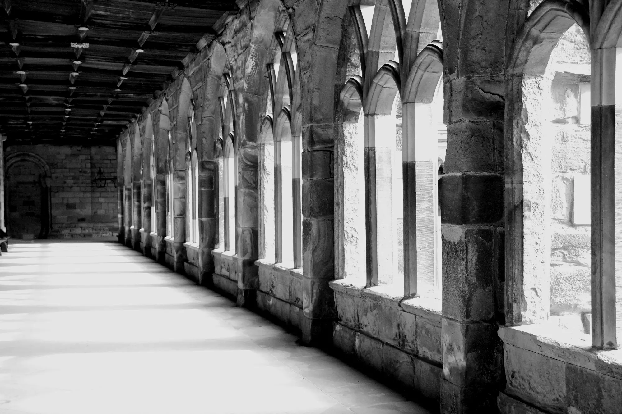 Light falling through the arches of Durham Cathedral cloister.